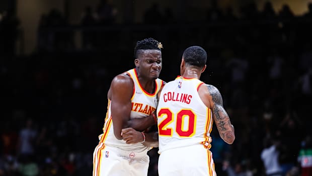 Clint Capela chest bumps John Collins.